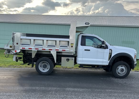 Municipal work truck with polished aluminum Morocco Welding dump body, side profile view