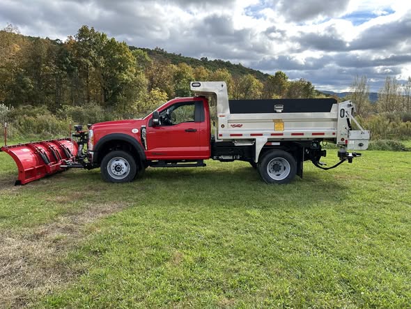 Side view of a PA Municipal work truck showing the Martin aluminum dump body and mounted Western Pro snowplow